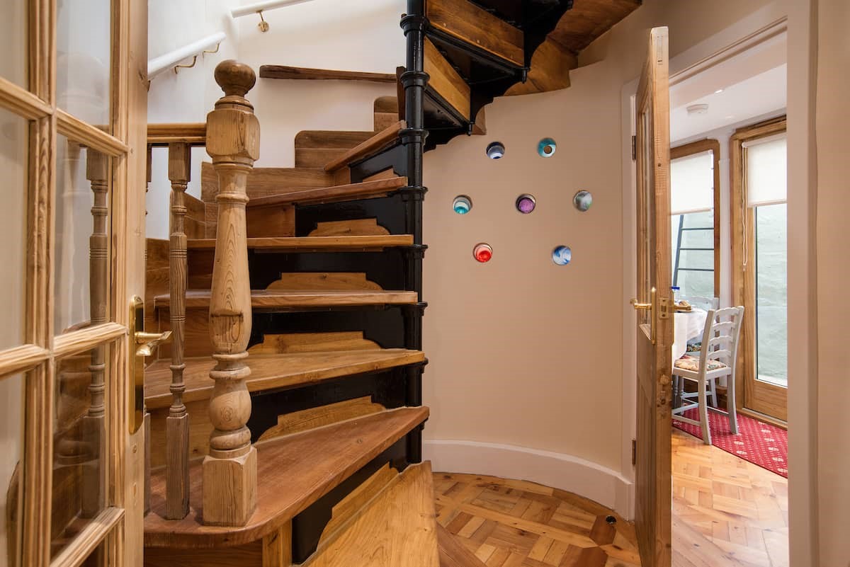 The Woodworker's Cottage - charming spiral staircase with colourful glass wall feature