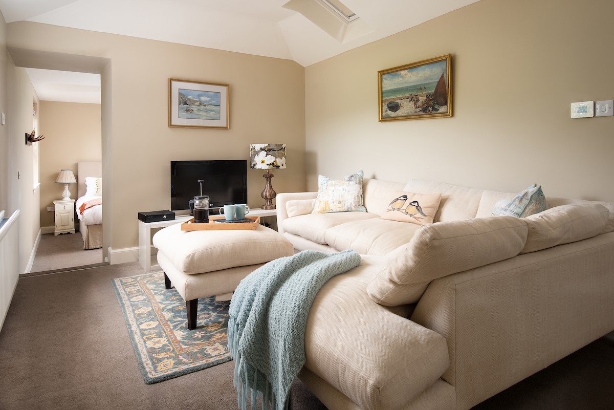 Seaview House - Annexe sitting room with steps leading down to the bedroom