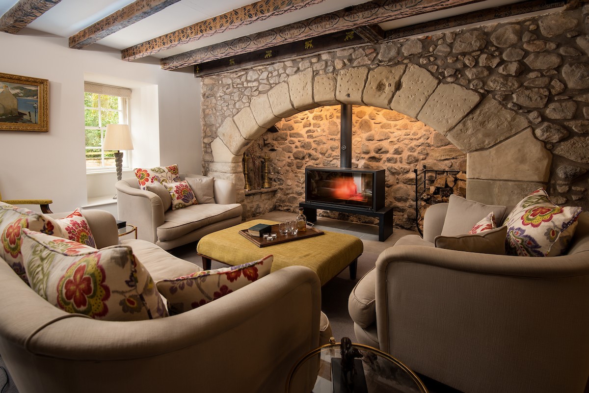 Old Purves Hall - comfortable sofas positioned around the large wood burning stove