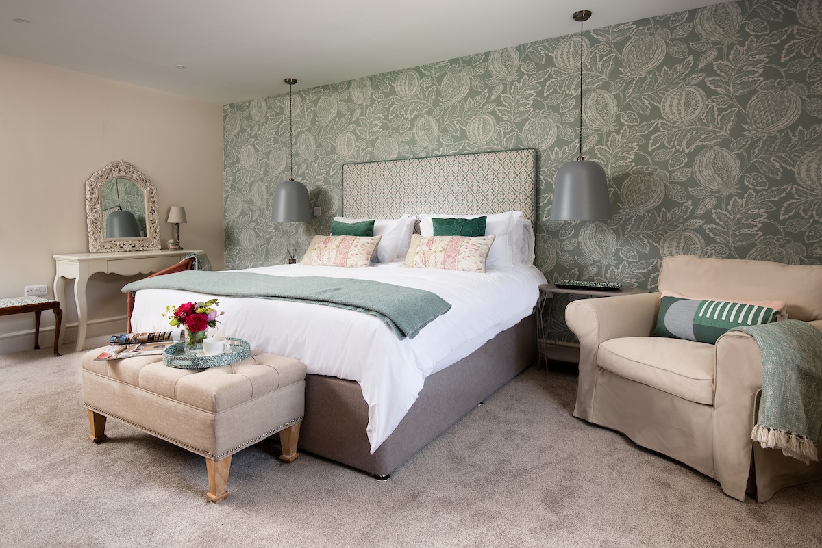 Partridge Lodge - master bedroom with superking double bed and views to the rear garden