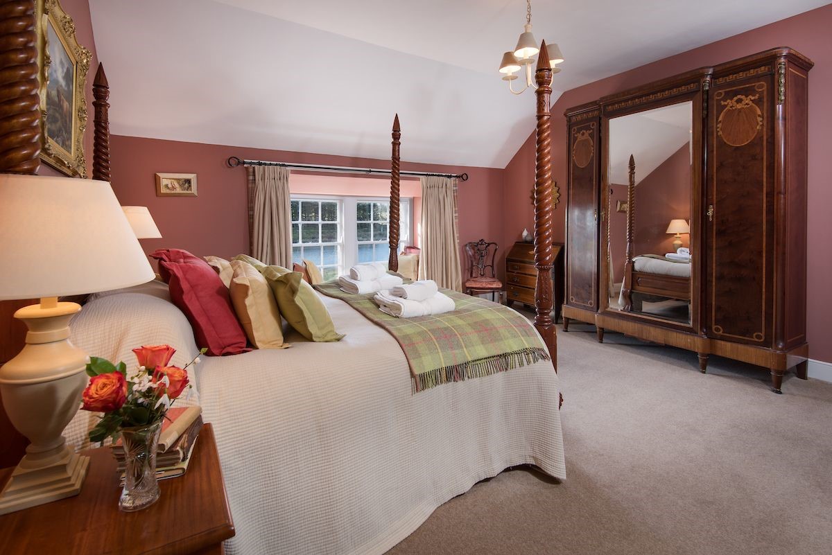 The Boathouse - bedroom two with four poster bed