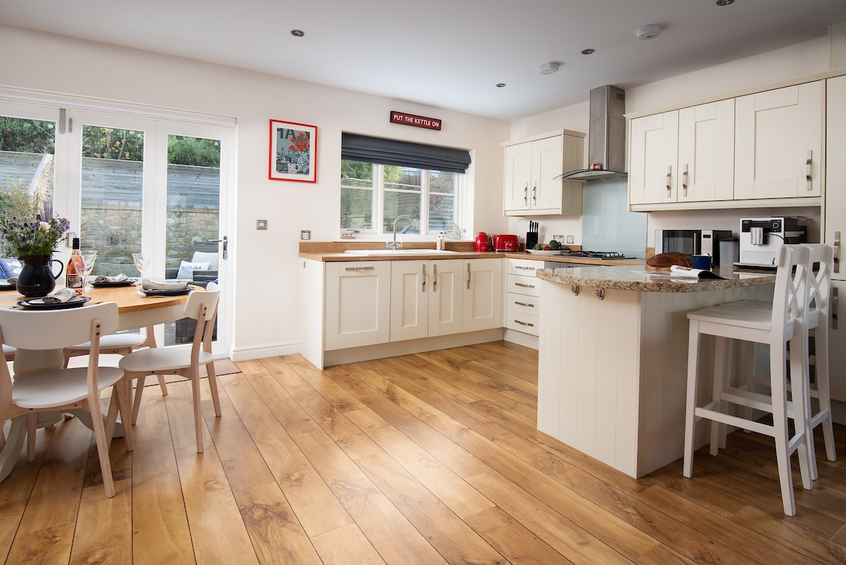 No. 6 - open plan, well-equipped kitchen with breakfast bar and two bar stools