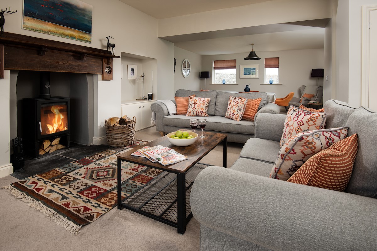 Farm Cottage - the cosy sitting room area with sofas set around the fireplace and wood burner