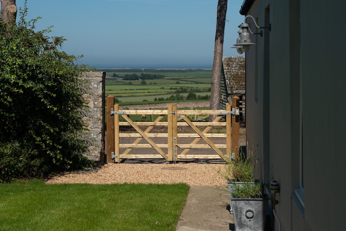 Overview Cottage - entrance gate and view towards Lindisfarne and the coast