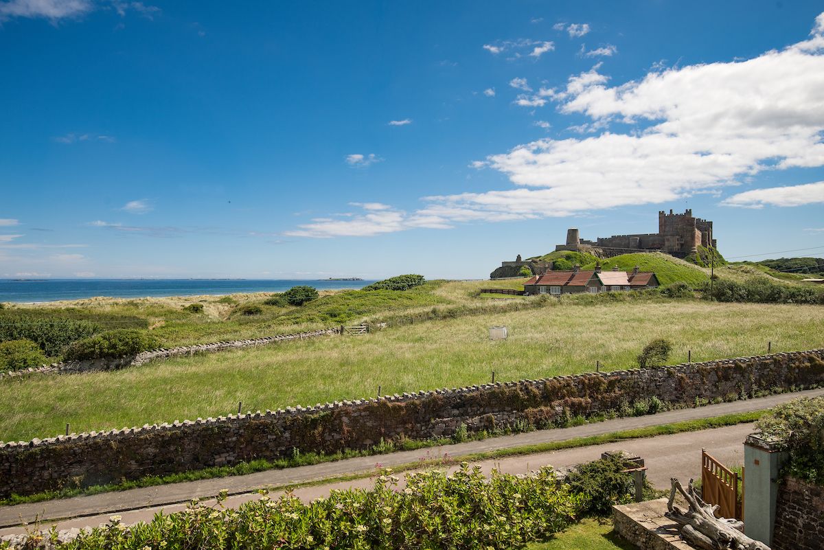 View of Bamburgh Castle and the sea from The Shieling holiday cottage, from Bamburgh on the Northumberland coast