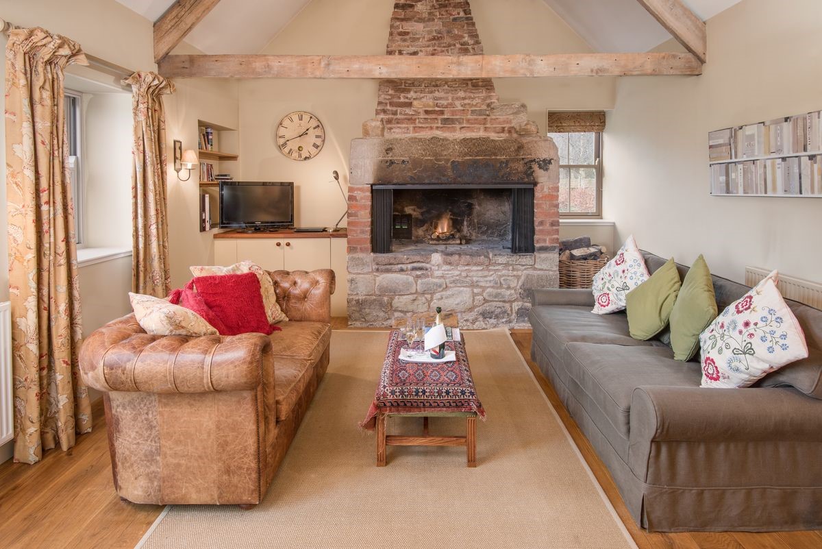 The Smithy, Crookham - sitting room with fire