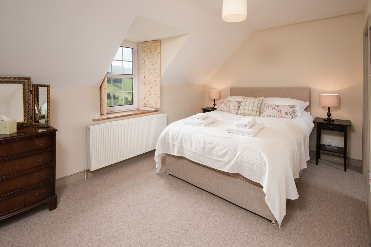 Bowmont Cottage - bedroom one with king size bed and views of the College Valley