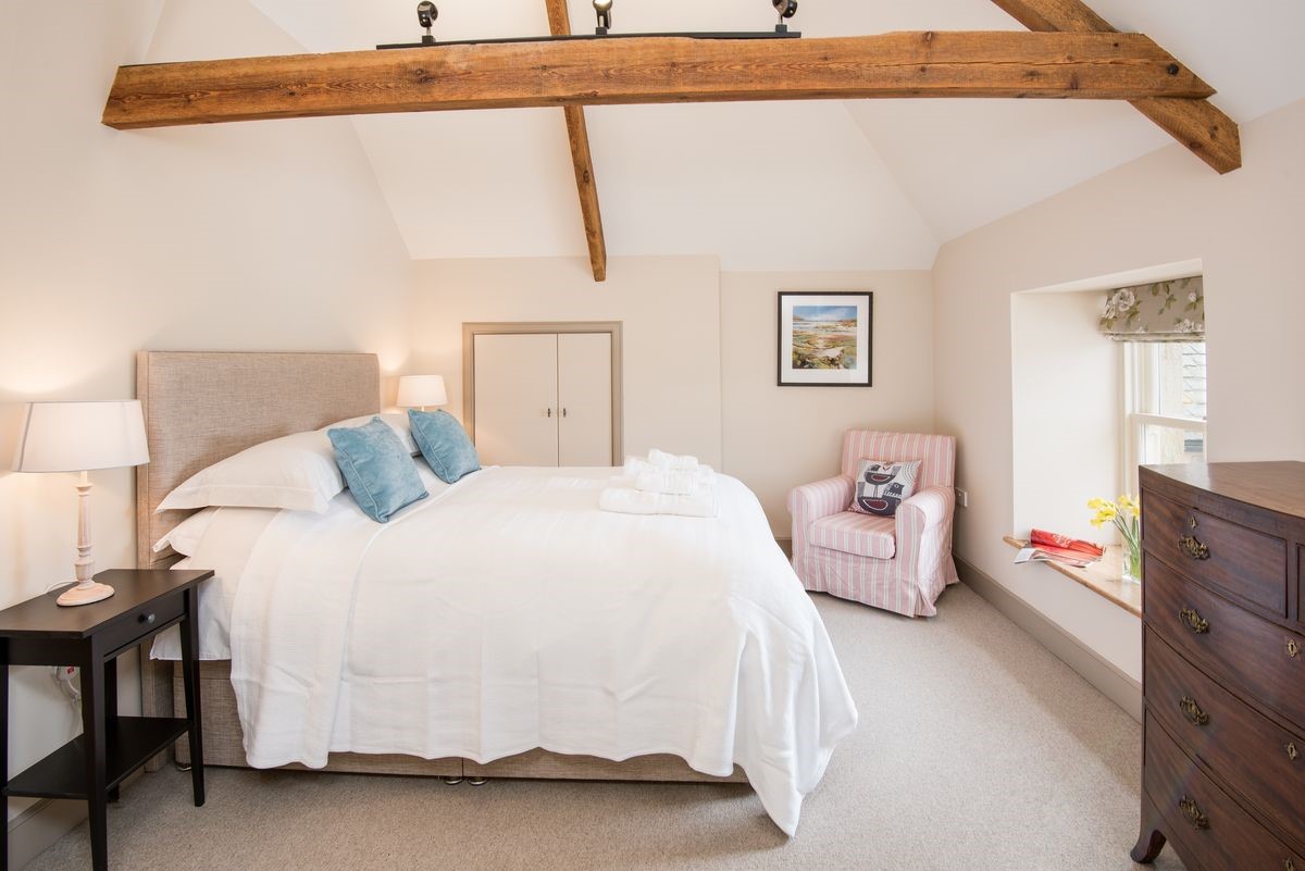 Crookhouse Mill - bedroom three on the first floor with king size bed, armchair, chest of drawers and en suite bathroom