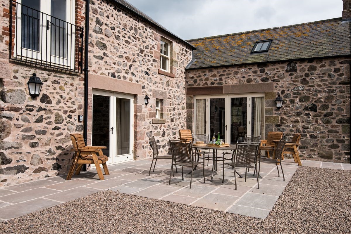 Crookhouse Mill - outside patio area with garden furniture and French doors leading into the kitchen and living area