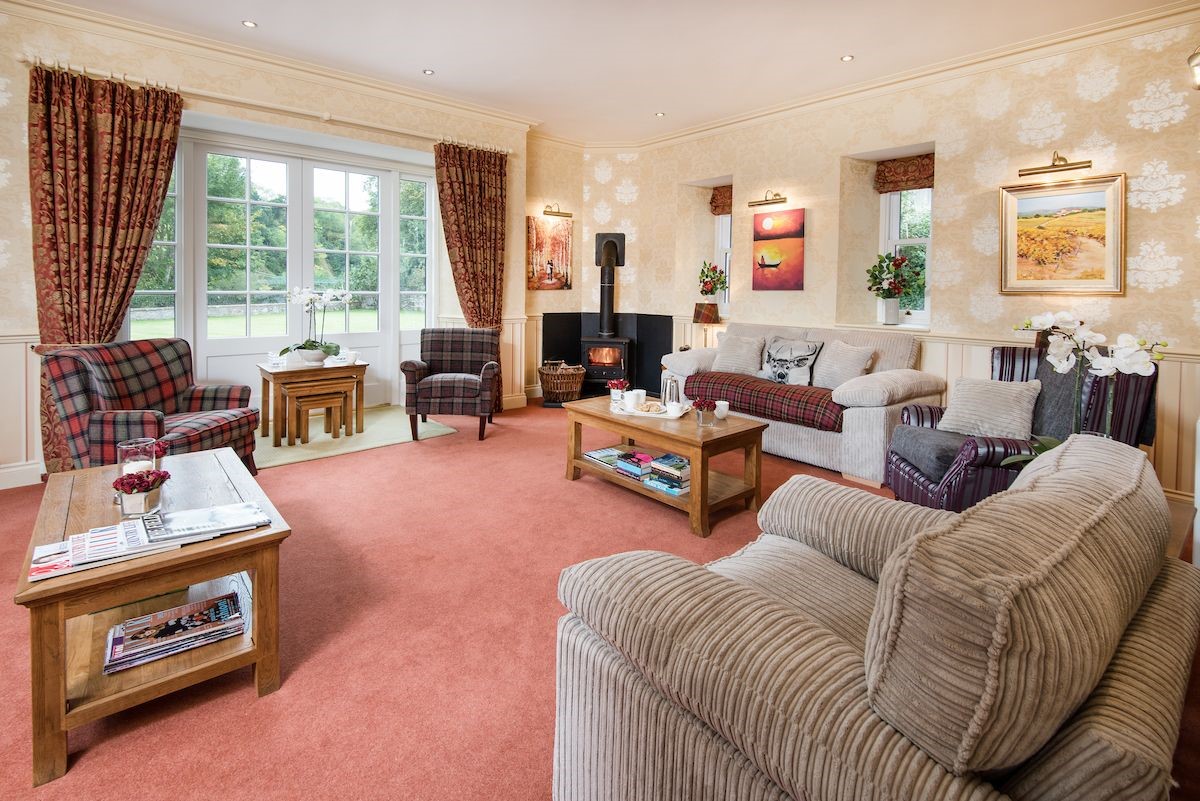 Dryburgh Farmhouse - sitting room with ample seating and a cosy wood burner