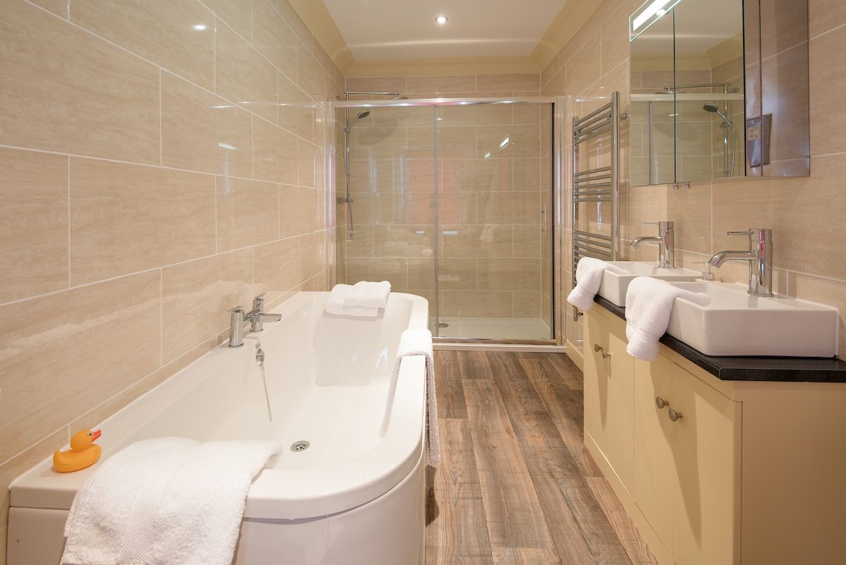 Dryburgh Farmhouse - en suite bathroom of bedroom five, featuring a bath with separate walk-in shower