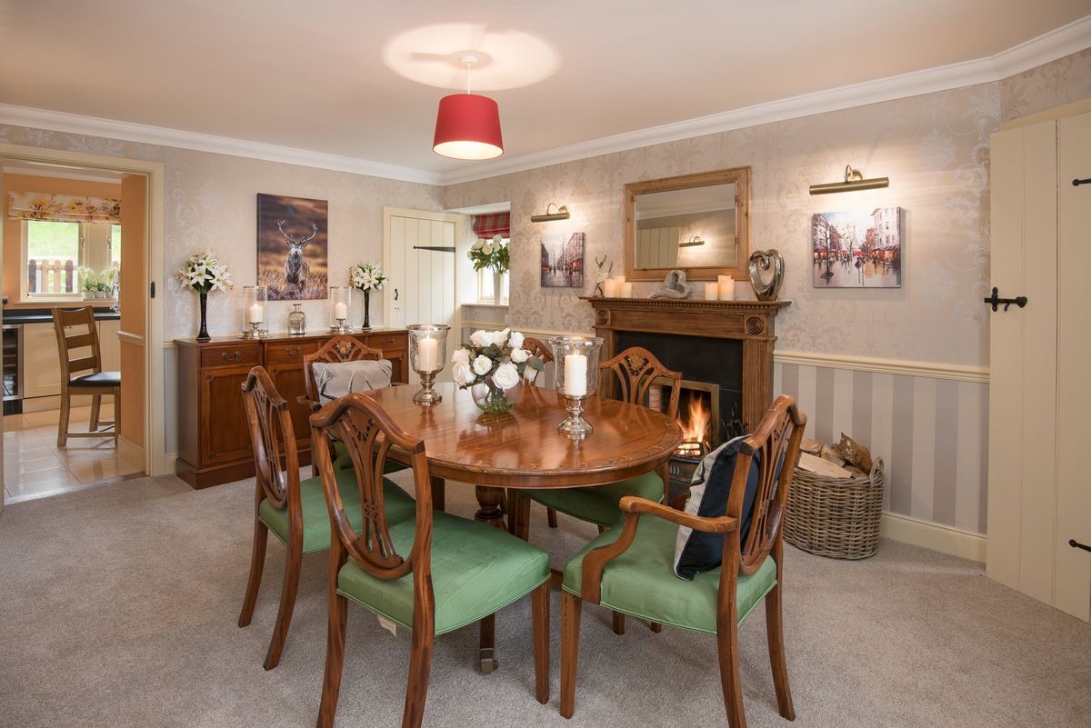 Dryburgh Stirling One - dining room with dining table seating six guests, sideboard and open fire