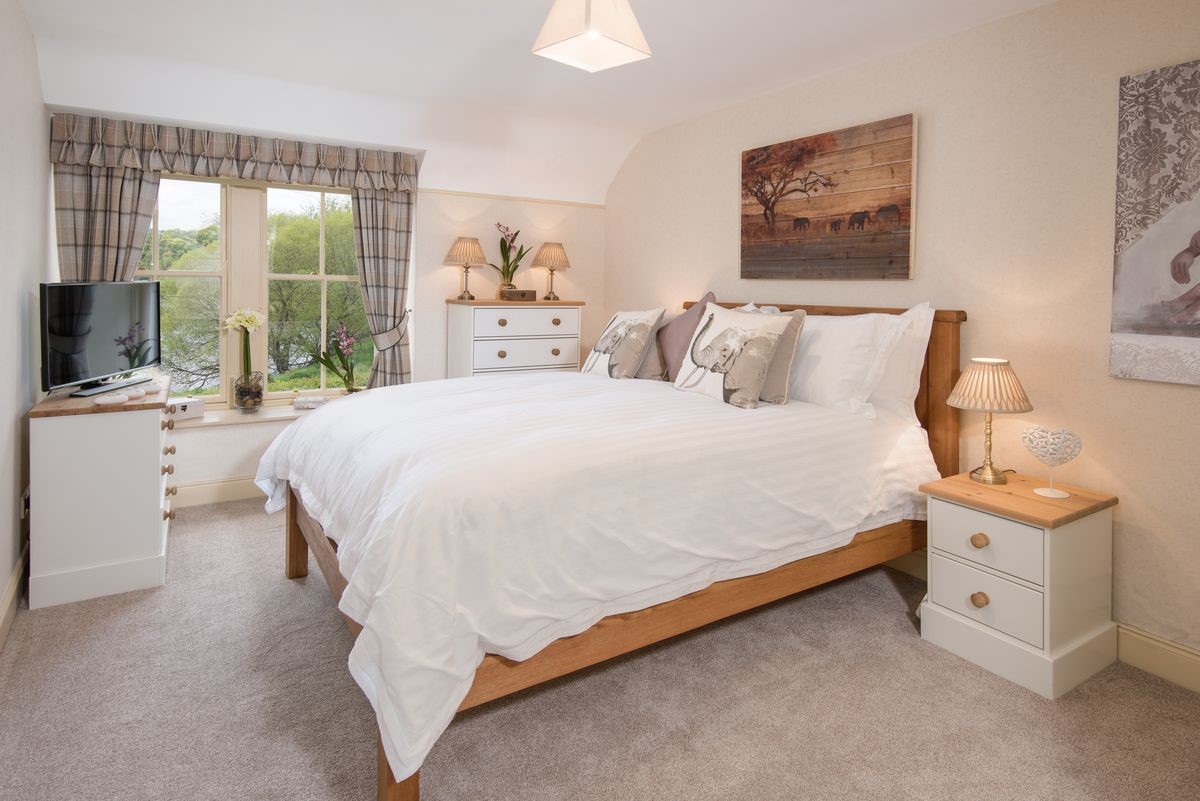 Dryburgh Stirling One - bedroom two with king size bed, side tables, chest of drawers and TV