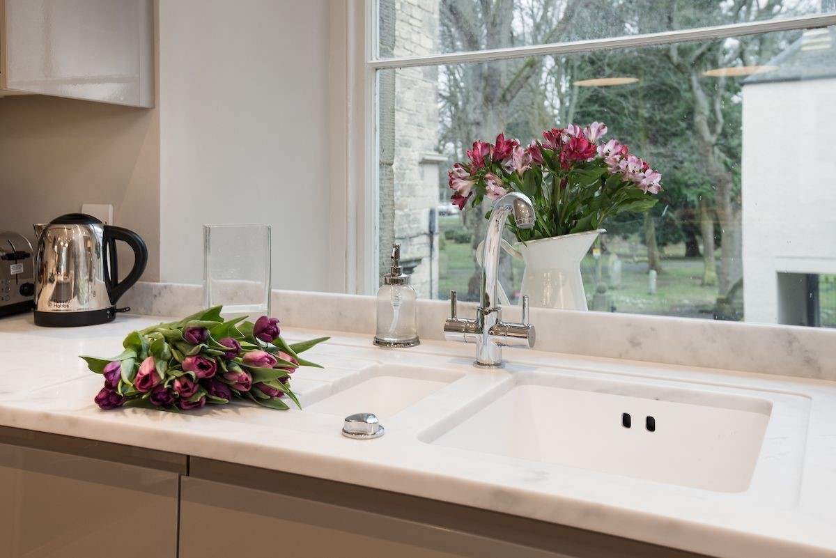Barclay House - arranging fresh flowers at the kitchen sink