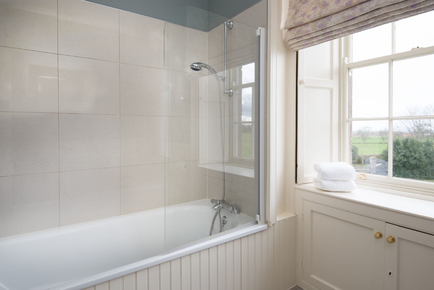 East House - family bathroom with bath and shower over, WC and basin