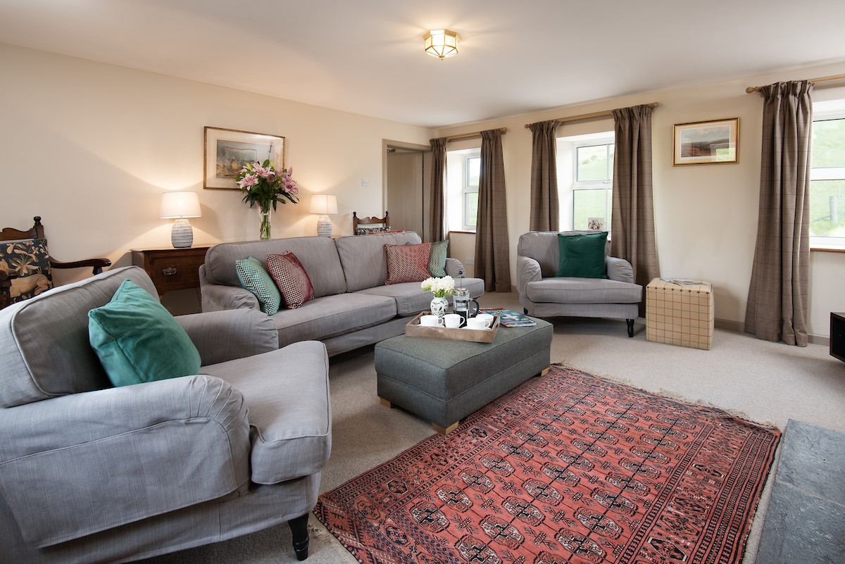 Dipper Cottage - sitting room with sofa, armchairs and footstool