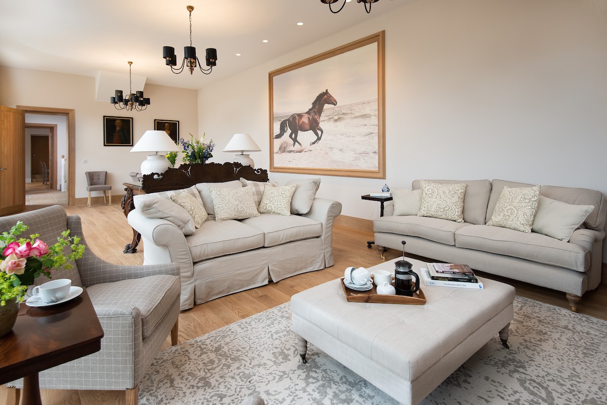 Beeswing - sitting room with muted furnishings and large equine-themed artwork