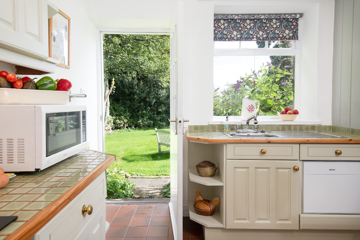 Milfield Hill Cottage - kitchen with rear door to the garden