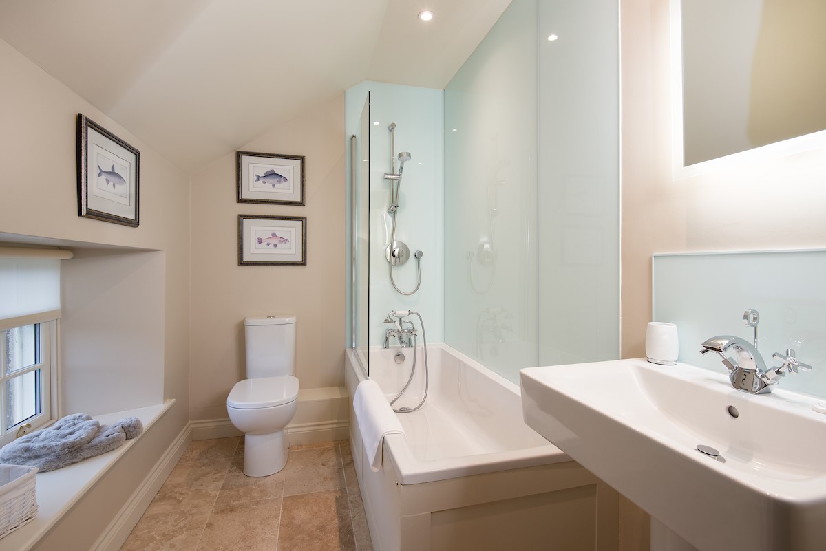 Countess Park - bedroom five en-suite bathroom with bath and shower over, WC and basin