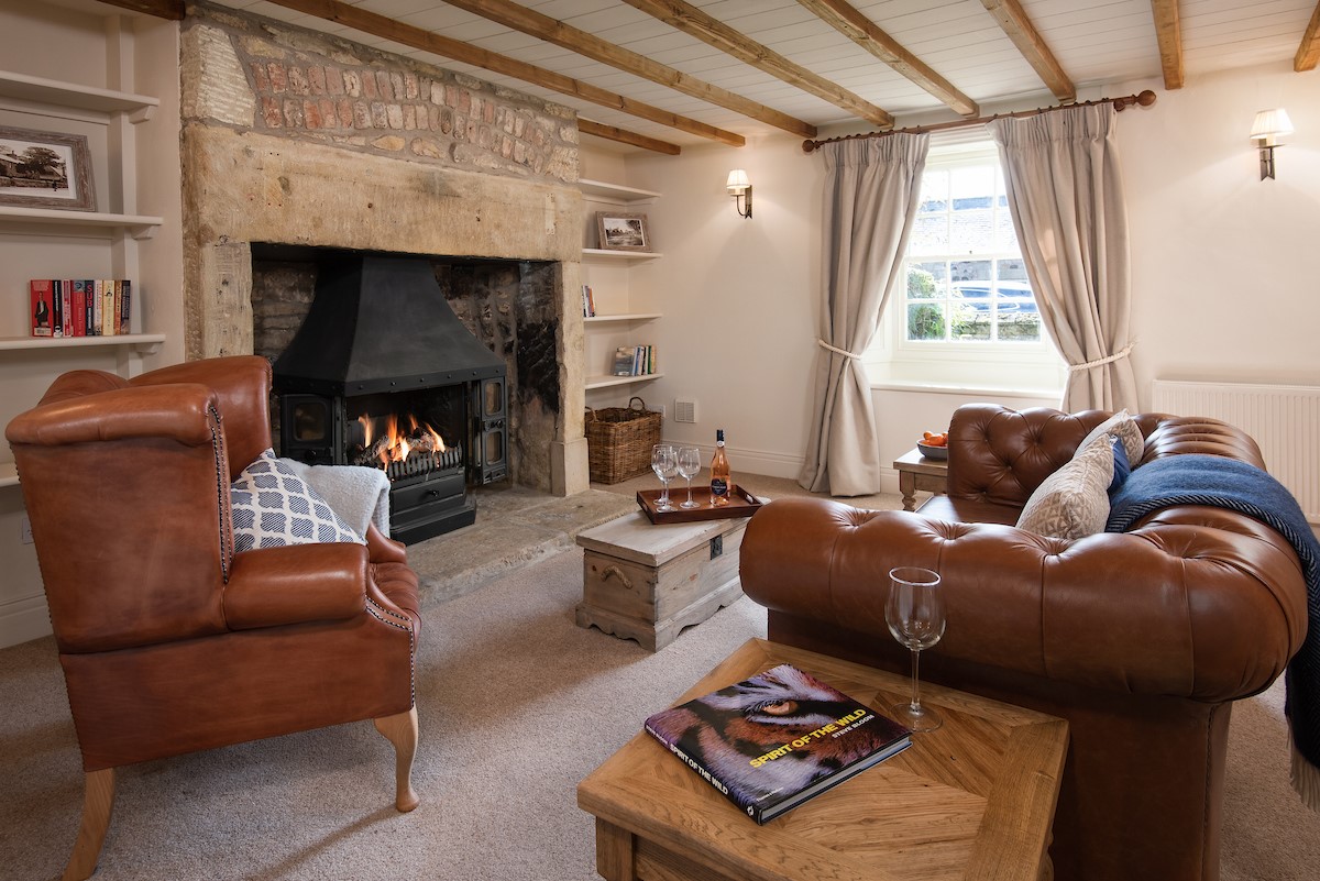 Bowls Cottage - sitting room two with large inglenook fireplace, leather sofa and armchair