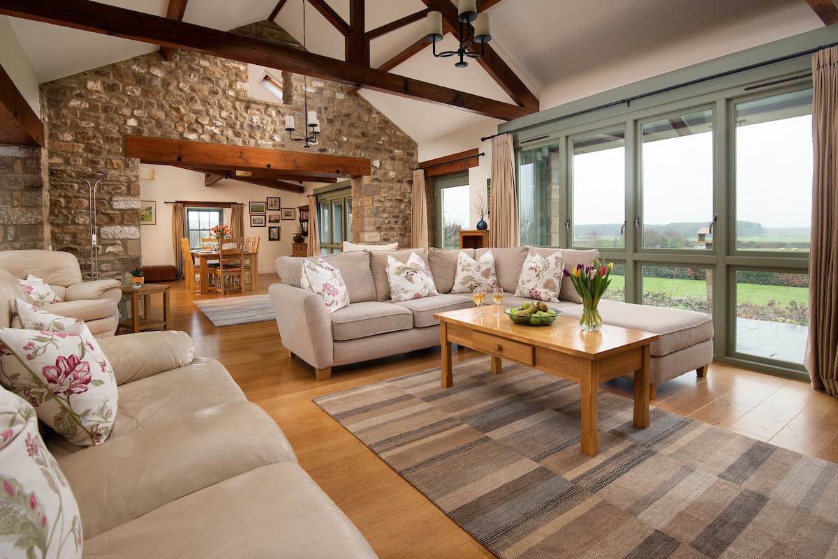 East Lodge - double height ceilings, feature beams and stone detailing throughout the living areas (1)
