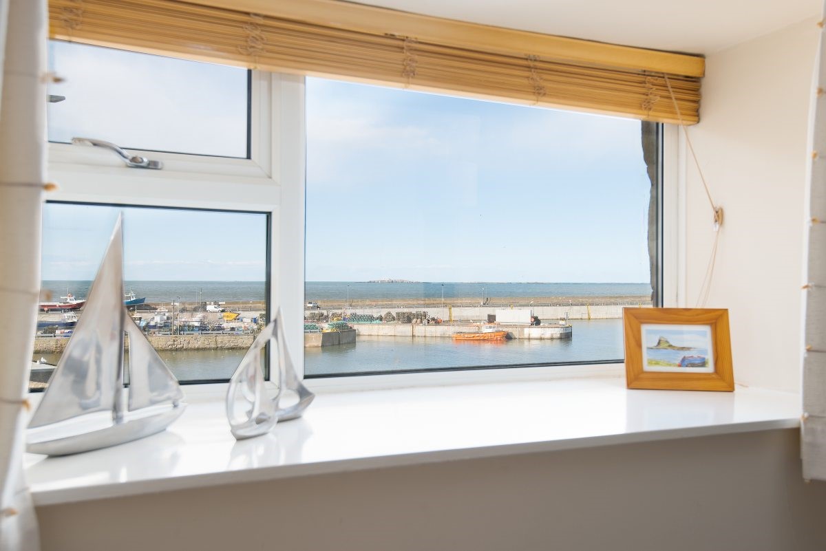 Farne View - windowsill details in bedroom two with views out to the harbour