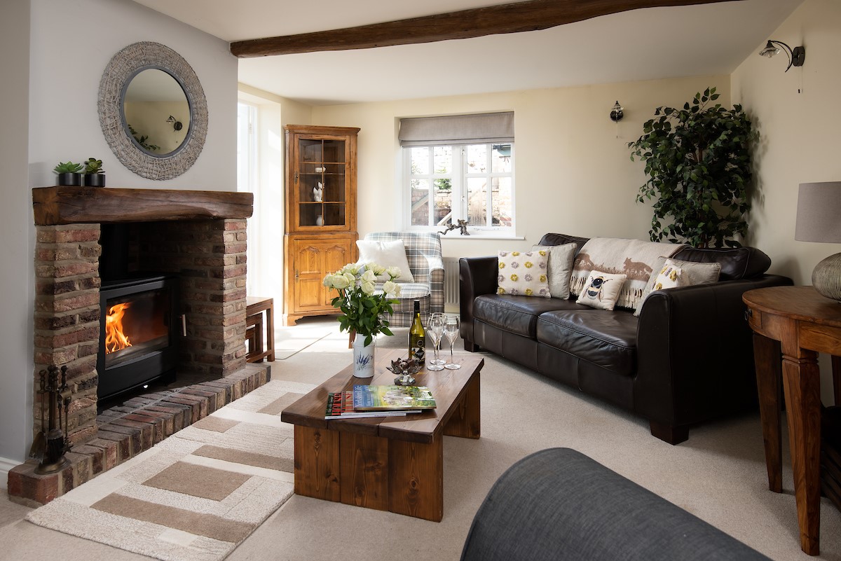 Rose Cottage, Huggate - the lounge with a cosy woodburning stove at its centre