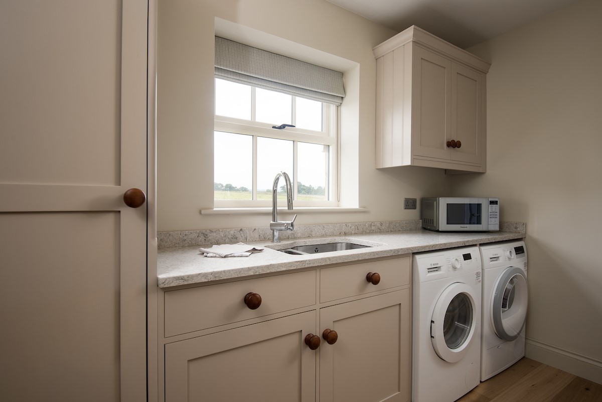 Risingham House - utility room with washing machine and tumble dryer