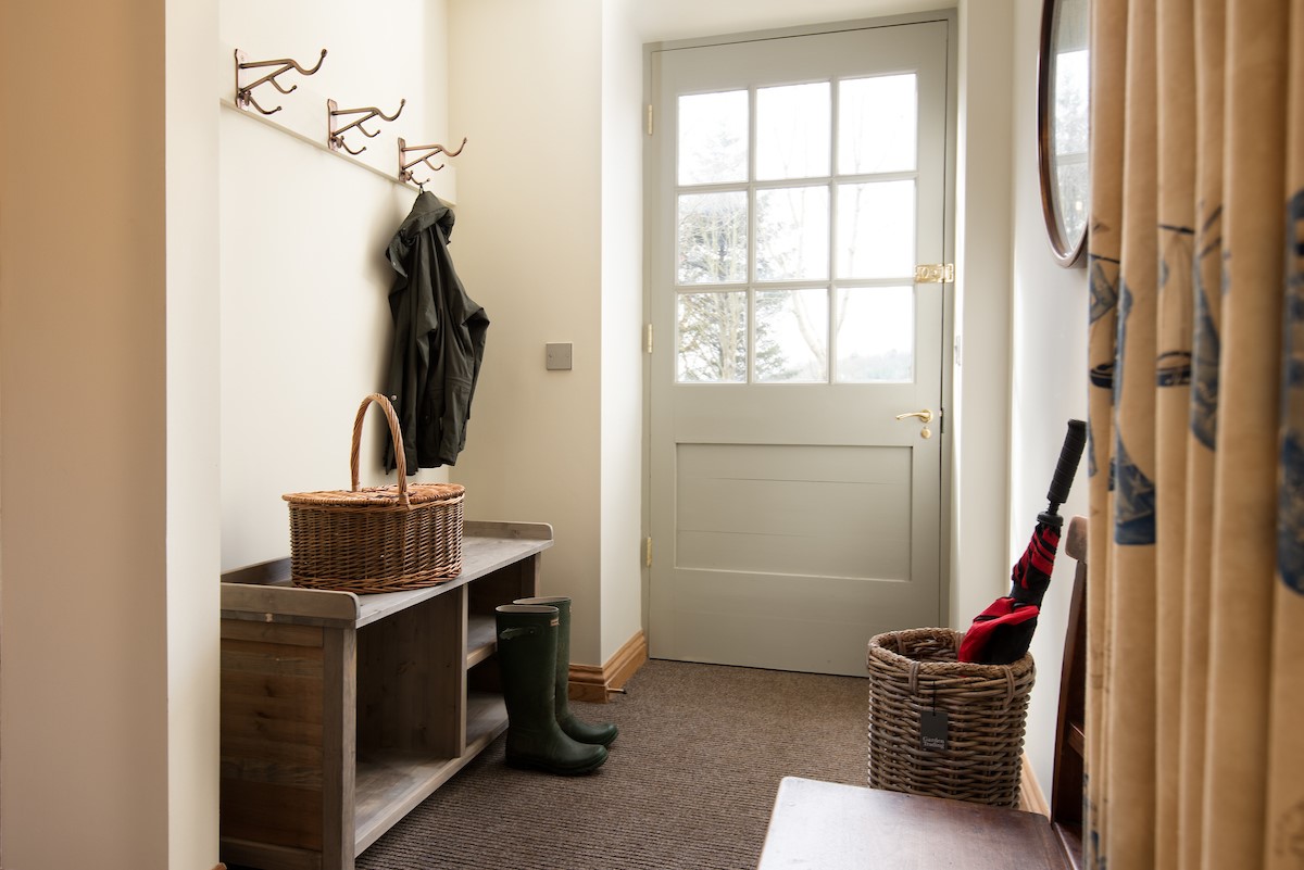Old Granary House - bright entrance hall with coat hooks and storage for outdoor kit