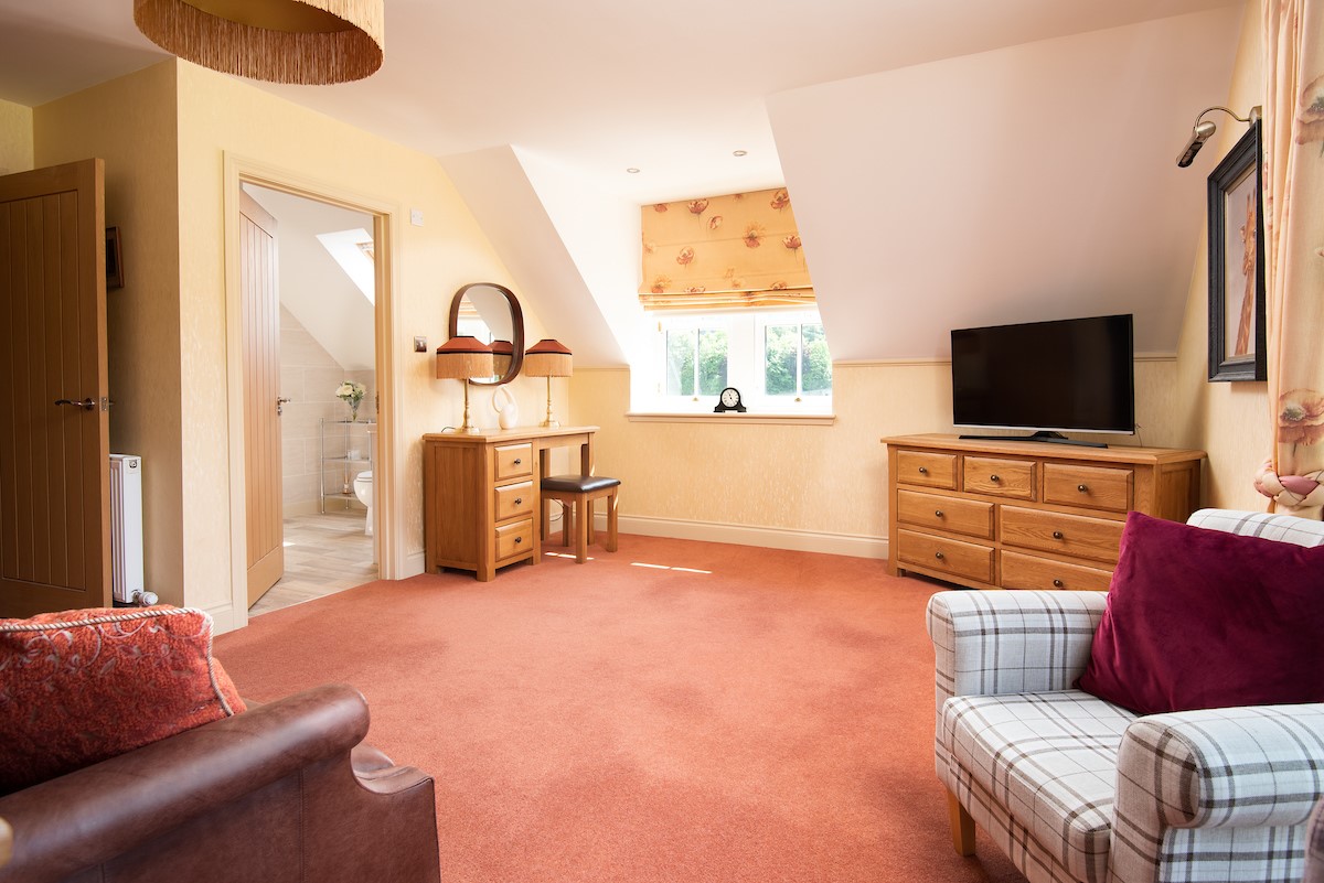 Dryburgh Farmhouse - bedroom two spacious sitting area with dressing table and flat screen tv
