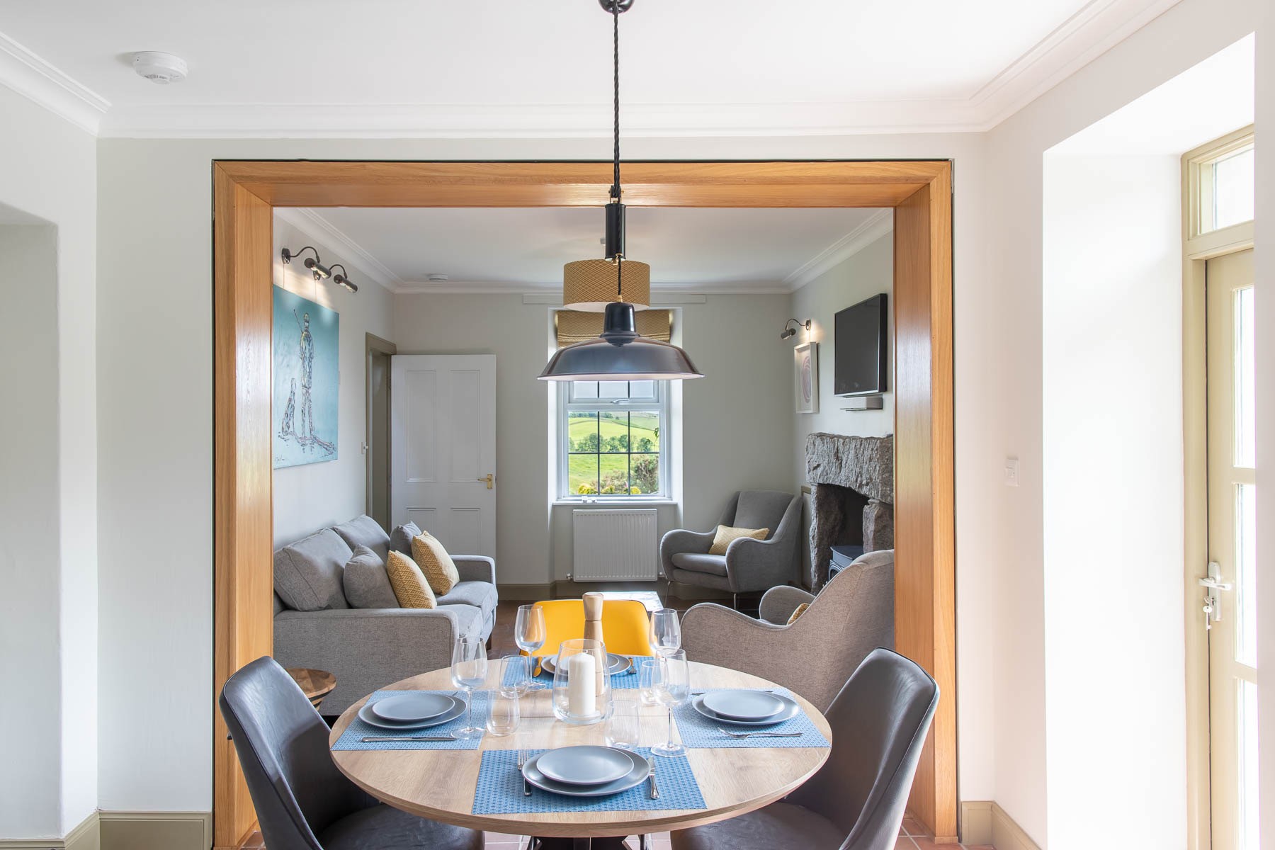 Culdoach Cottage - open plan dining area with cosy sitting room beyond