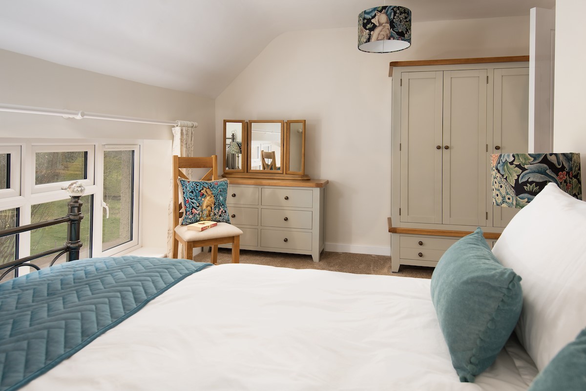 West Mill Cottage - bedroom one has ample storage within the chest of drawers and wardrobe