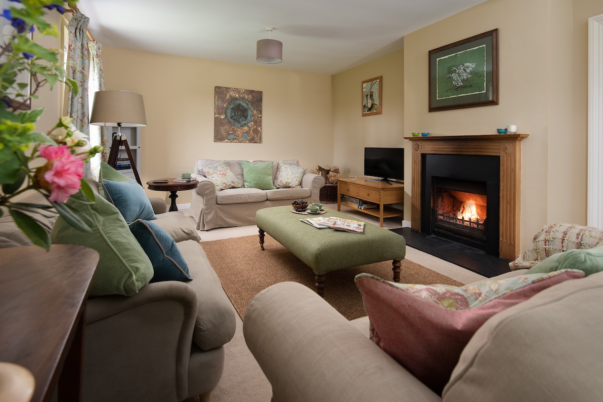 Pirnie Cottage - the sitting room with large sofas and open fire