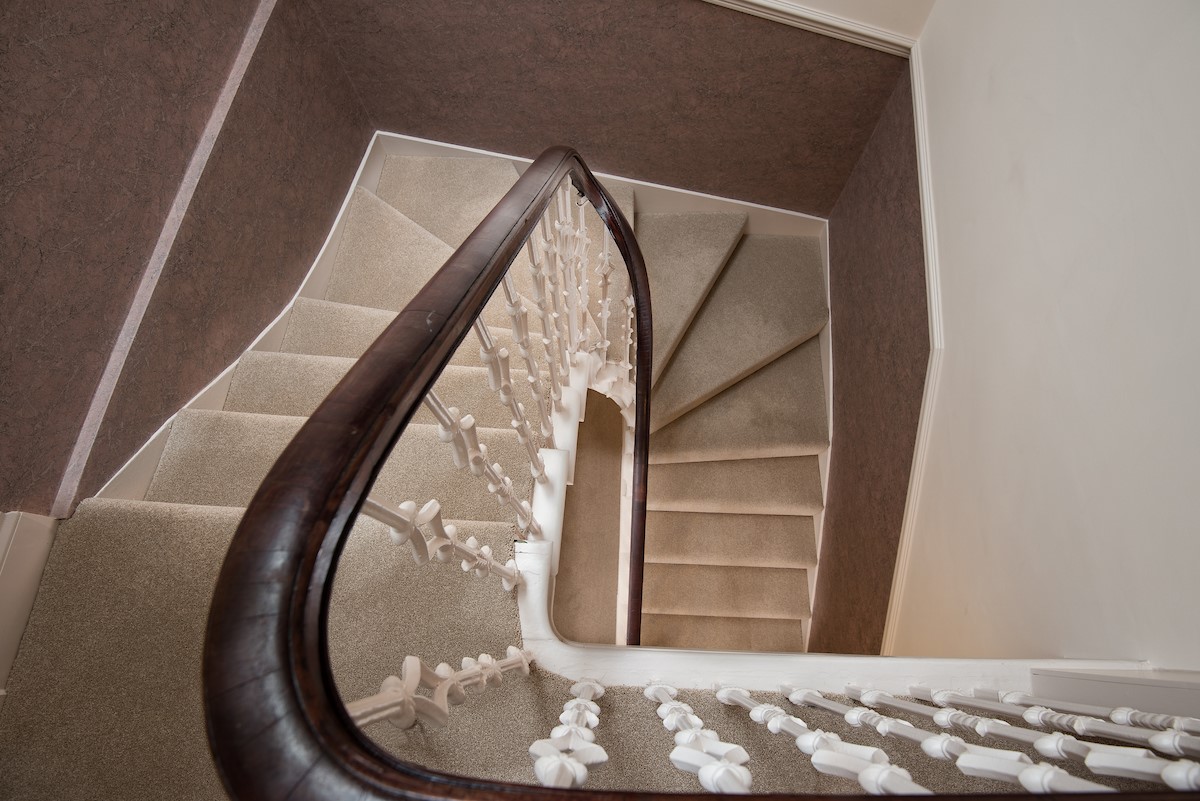 School View - graceful spiral staircase leading up the main living area