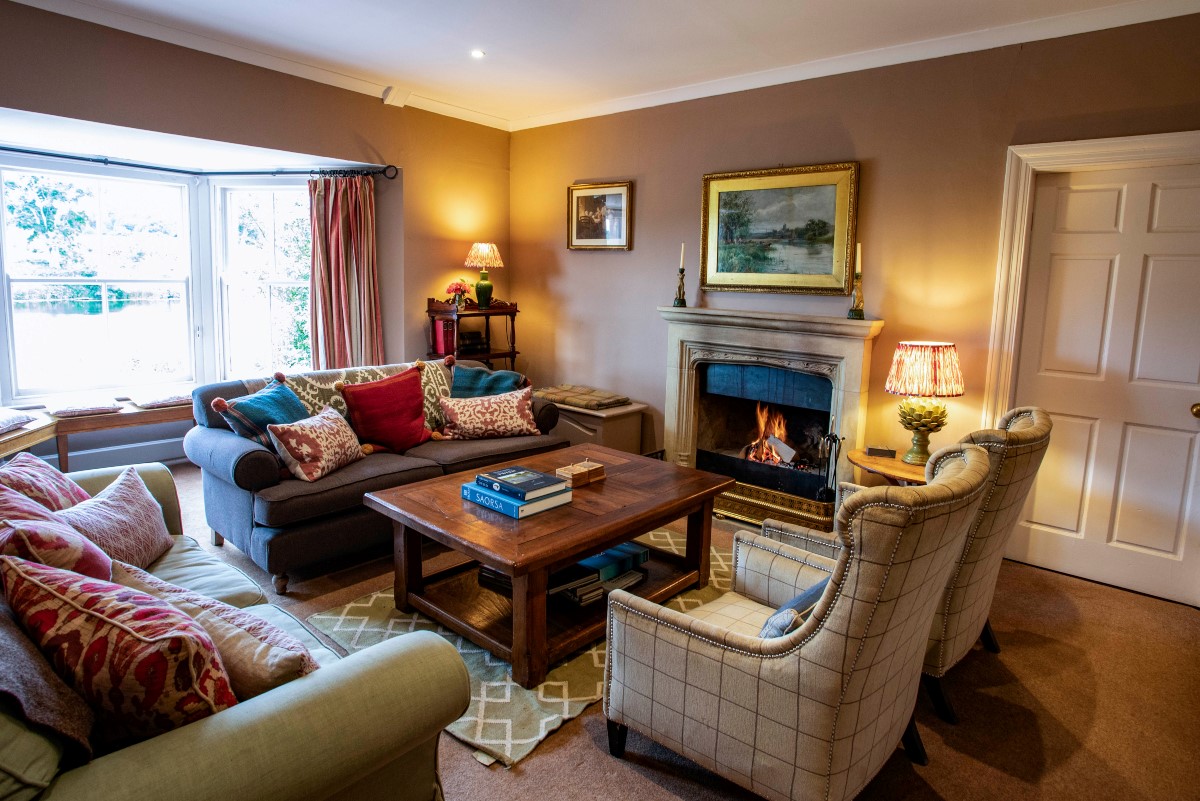 The Boathouse - the drawing room with bay window and views of the River Tweed