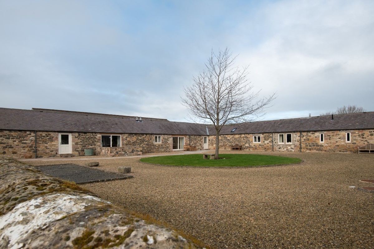 Long Byre - external views of the property to the left with enclosed patio in the shared courtyard