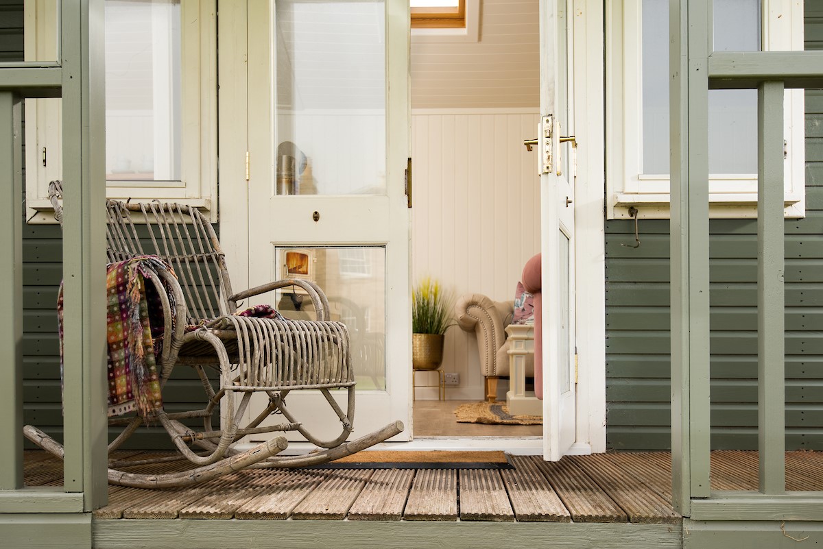 Seaview House - summer house porch with rustic rocking seat