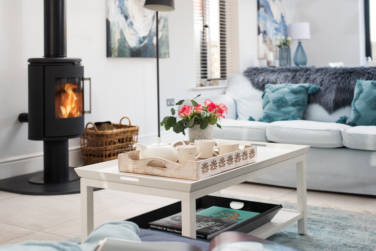 Duneside House - bright and airy sitting room with modern log burner