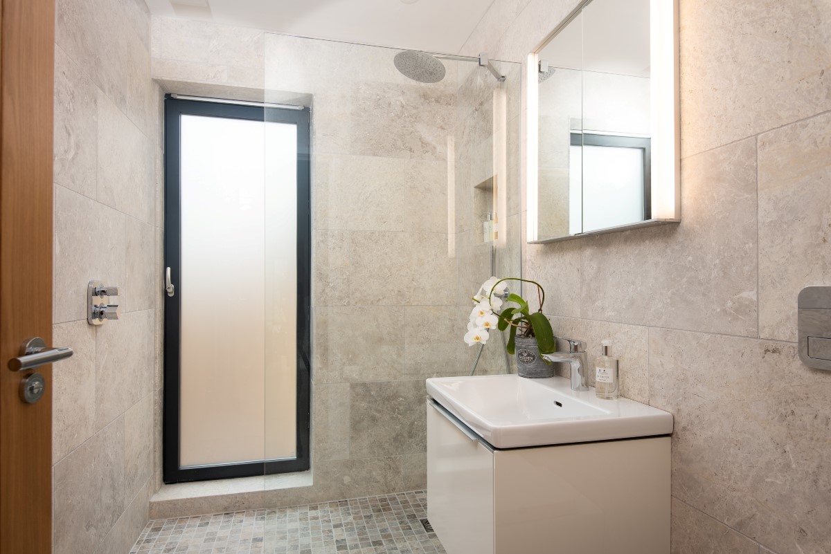 The Maple - family bathroom with rain forest shower head, basin, WC and direct access to the outdoor Shaanti Bath