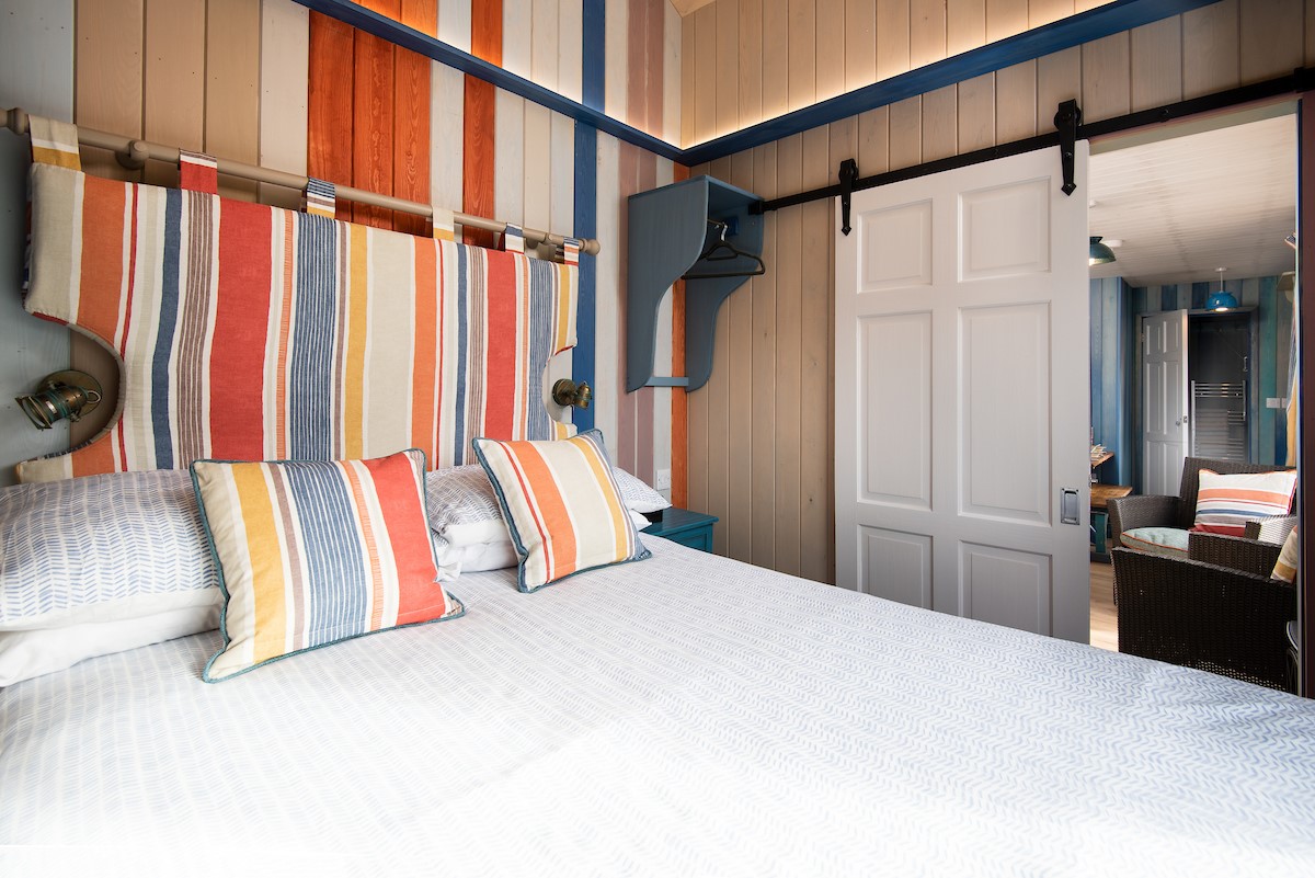 Berrington Beach Hut - ground floor bedroom with deckchair stripes adding a fun touch