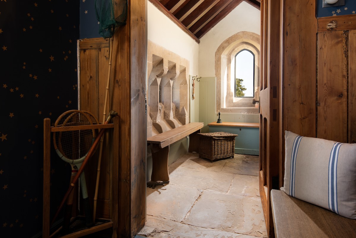 Lindisfarne View - the characterful boot room with stone floor, vaulted ceiling and original arched window