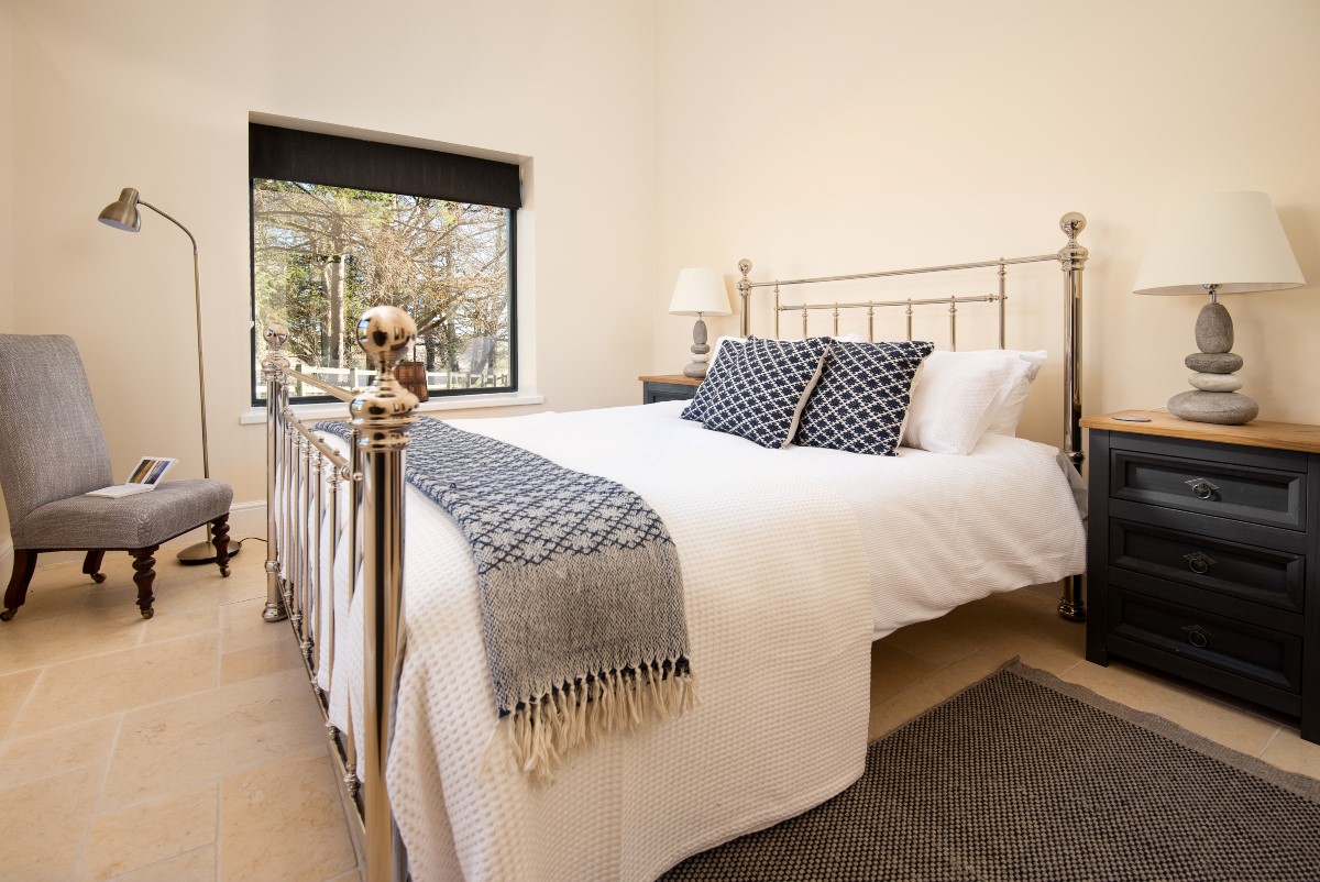 Tutor's Lodge - bedroom one features a vaulted ceiling making the room bright and airy