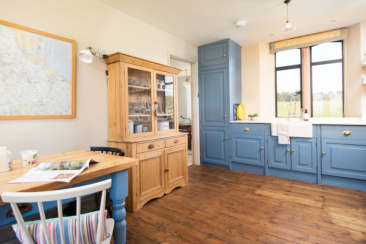 Lindisfarne View - the kitchen has a rustic vibe with wooden floor boards and pine dresser