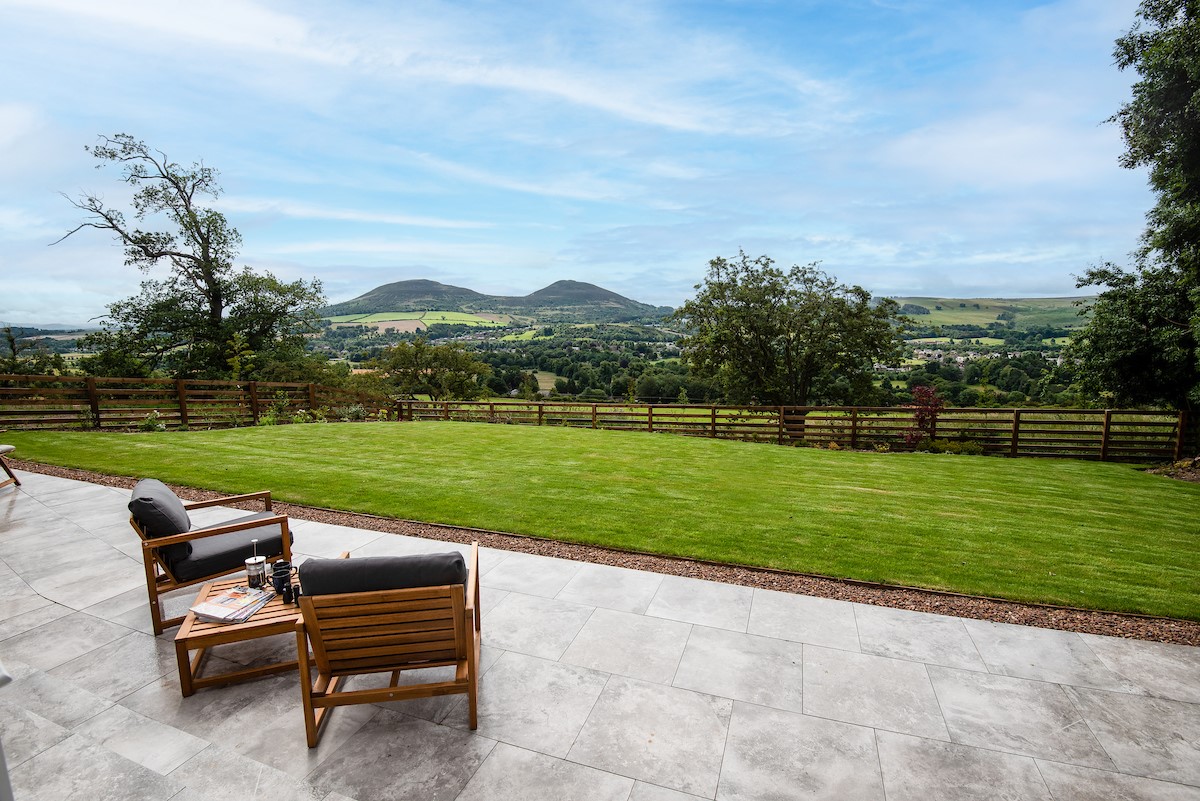 The Sheep Fold - large patio to the rear of the property with lawned garden beyond