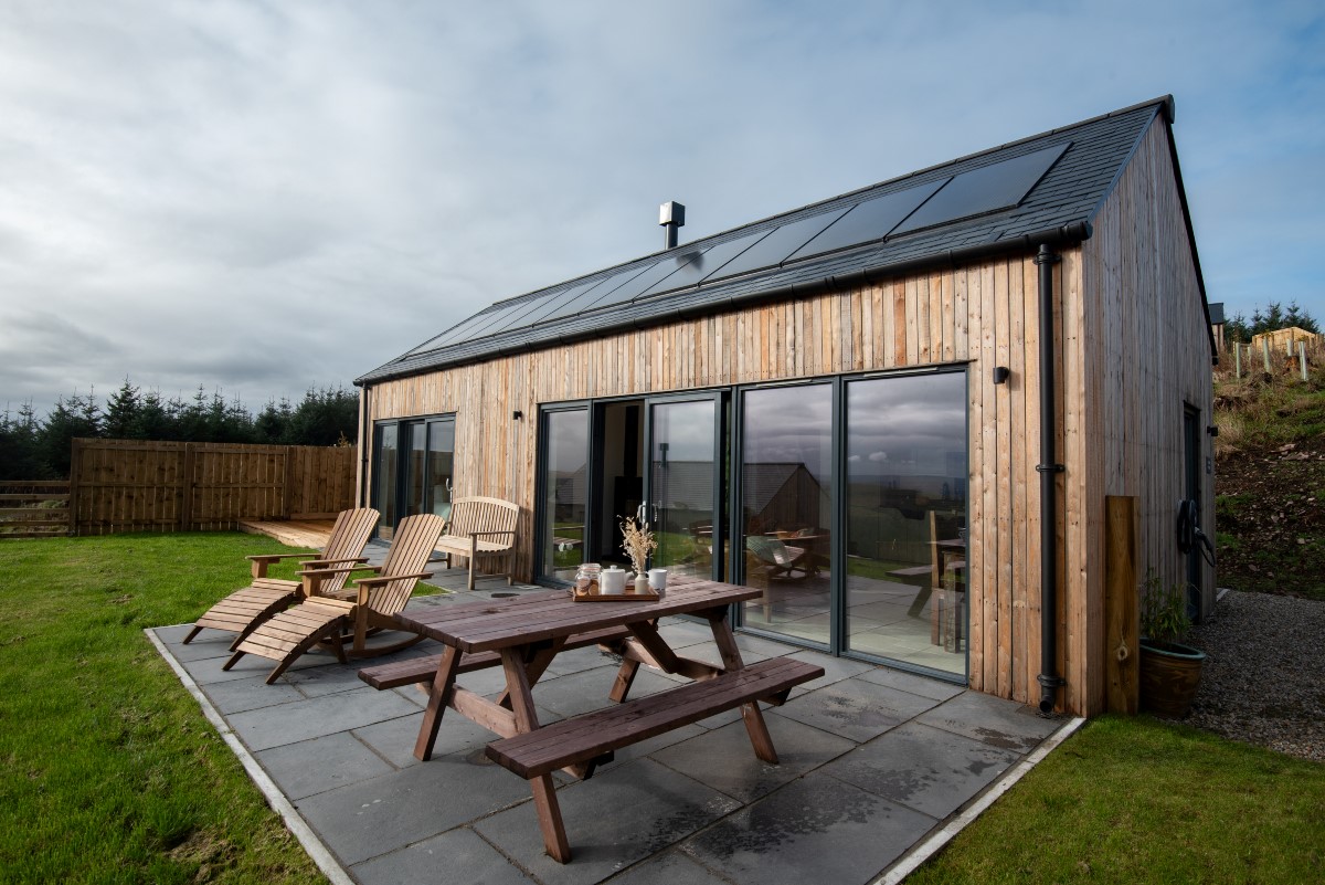 The Oak - front exterior with large bi-fold doors and patio area
