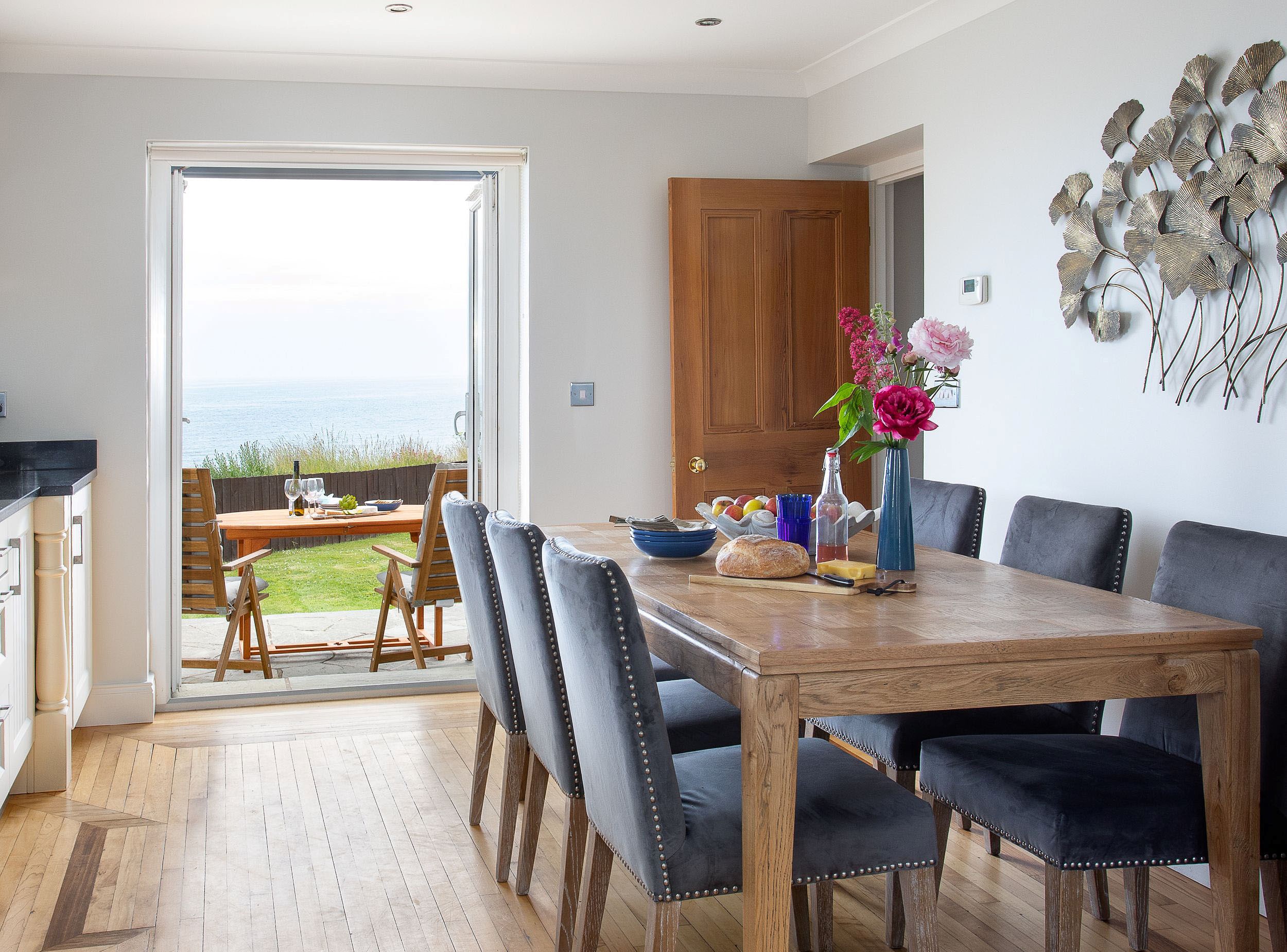 Sea Breeze - kitchen and dining table with French doors leading out to the patio
