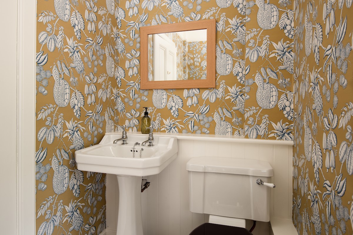 Wark Farmhouse - ground floor cloakroom with statement wallpaper