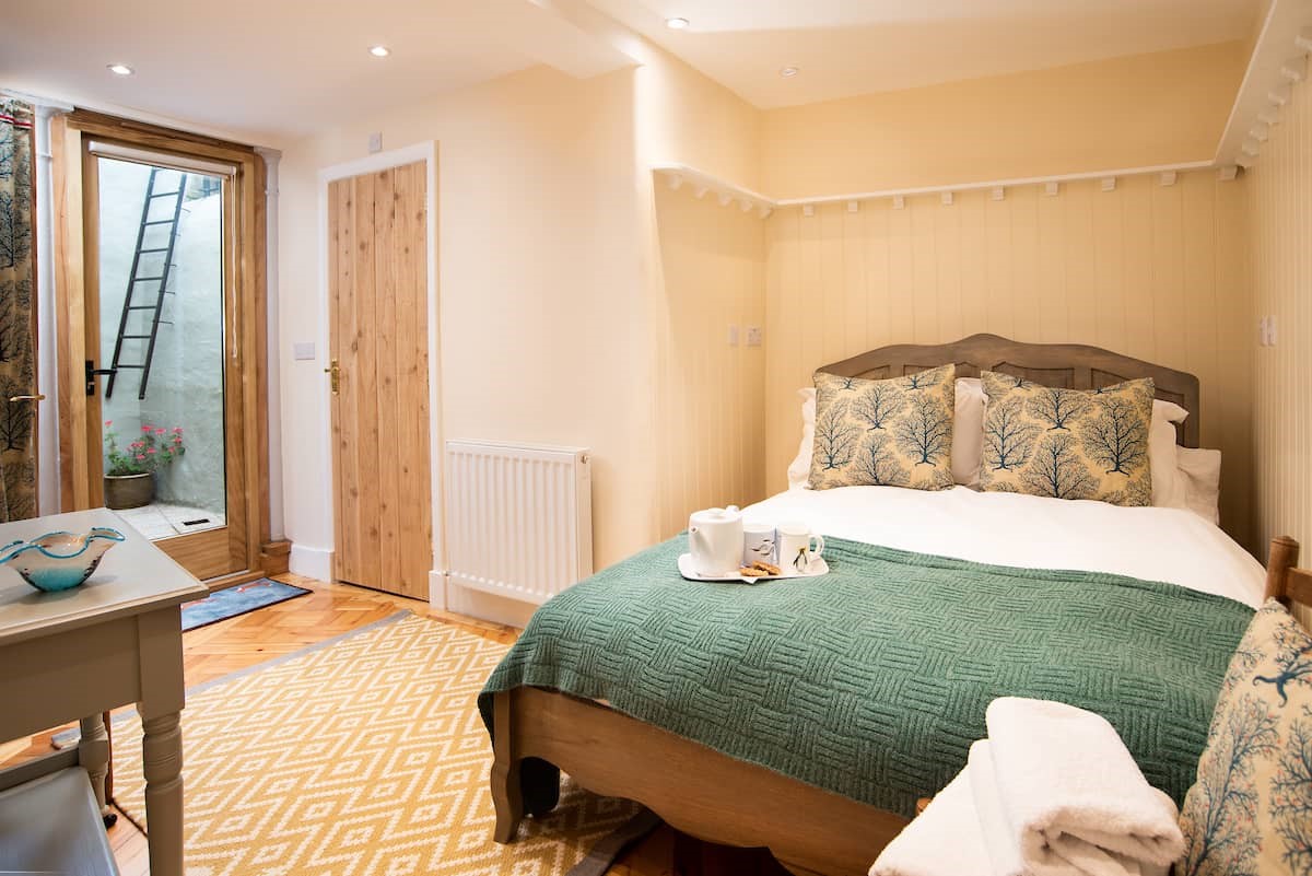 The Woodworker's Cottage - bedroom one on the ground floor with double bed and access to courtyard