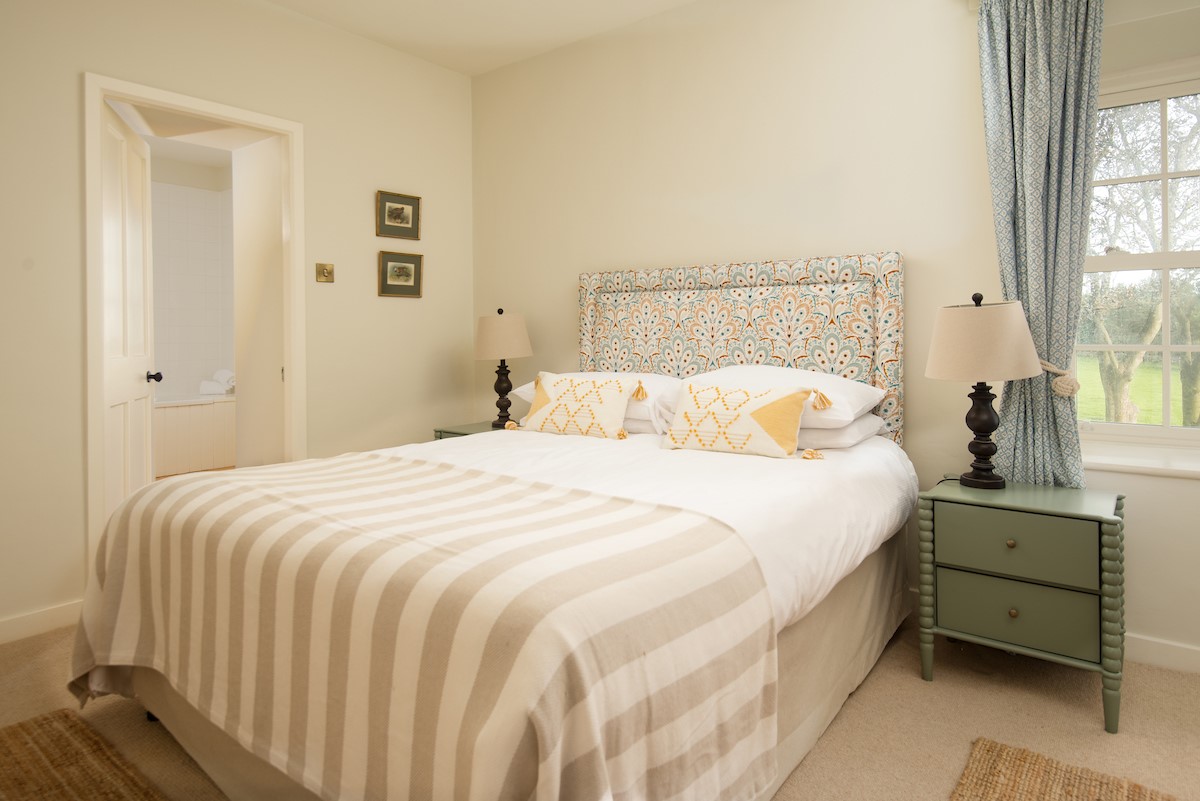The Old Vicarage - bedroom four with double bed and en-suite bathroom beyond