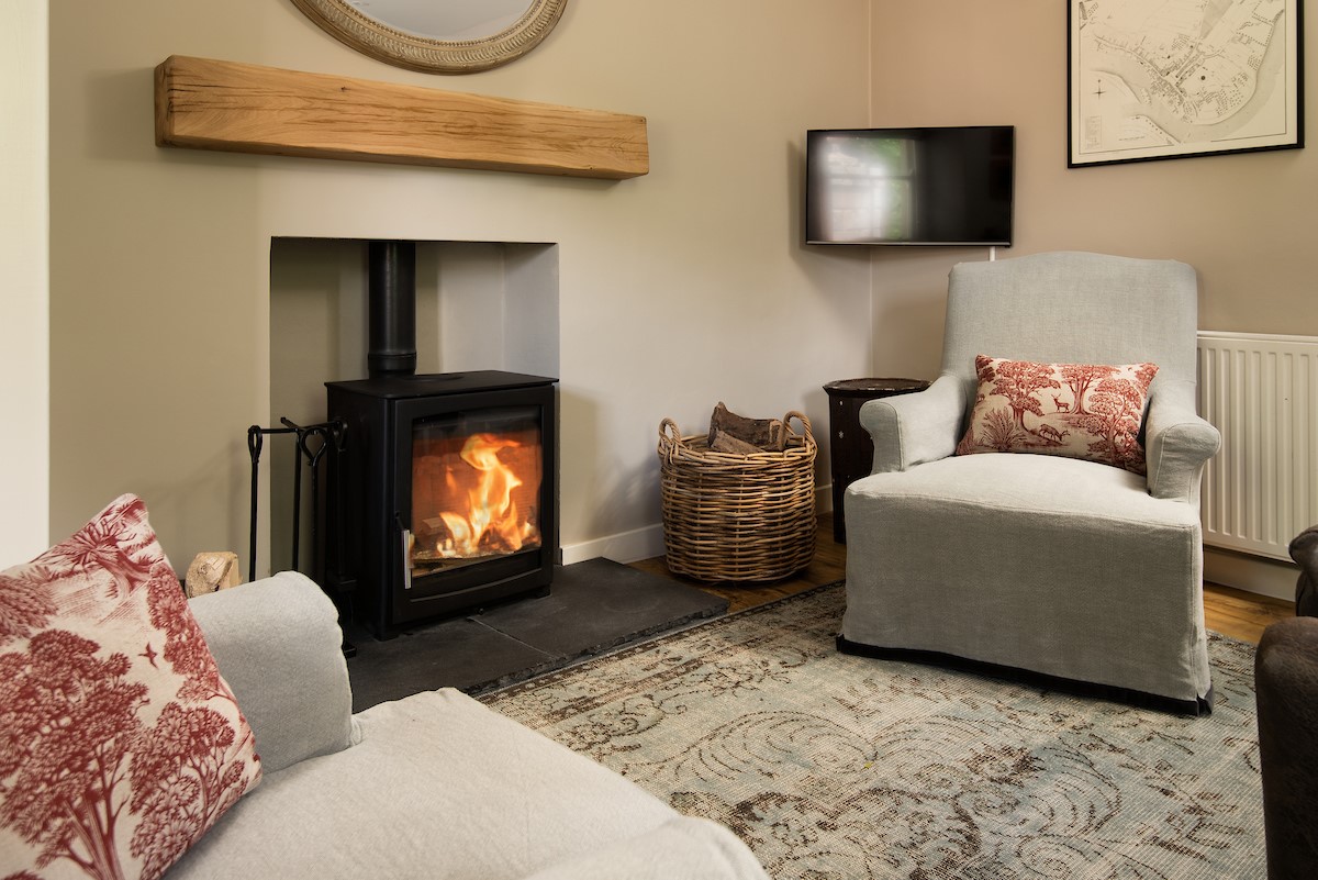 Crailing West Lodge - the cosy wood burning stove in the lounge